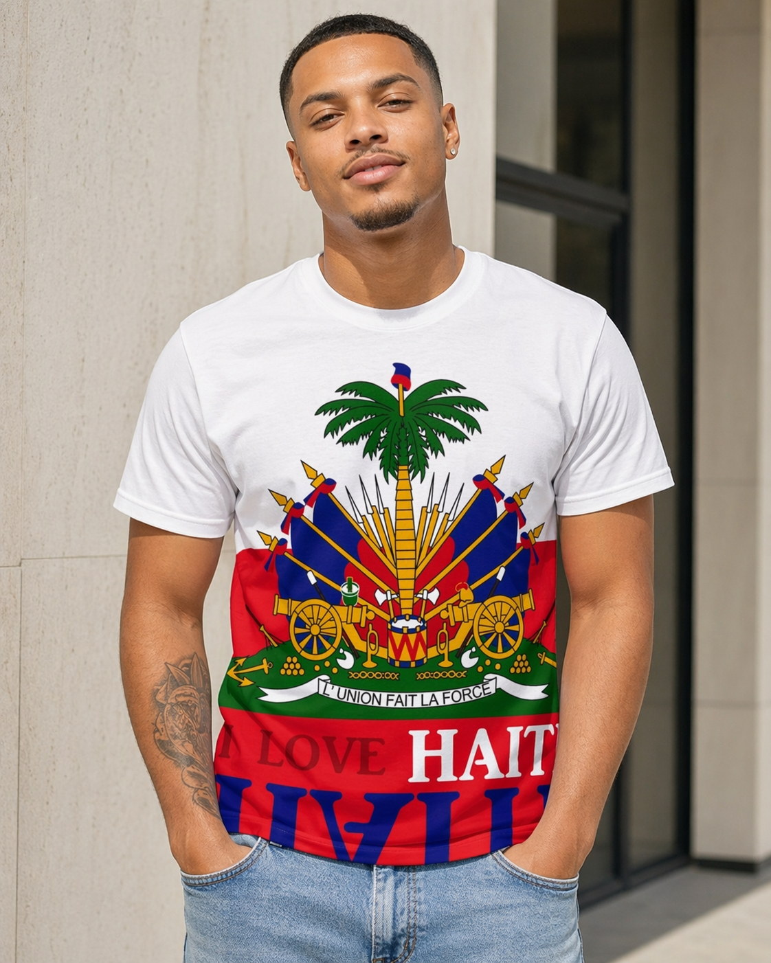 Man wearing a white t-shirt with a colorful design and 'Love Haiti' text.
