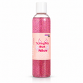 A clear plastic bottle filled with sparkling pink glitter and topped with a white cap, featuring a pink label that reads 'Naughty But Nice' with small angel graphics. The product is photographed on a clean white background.
